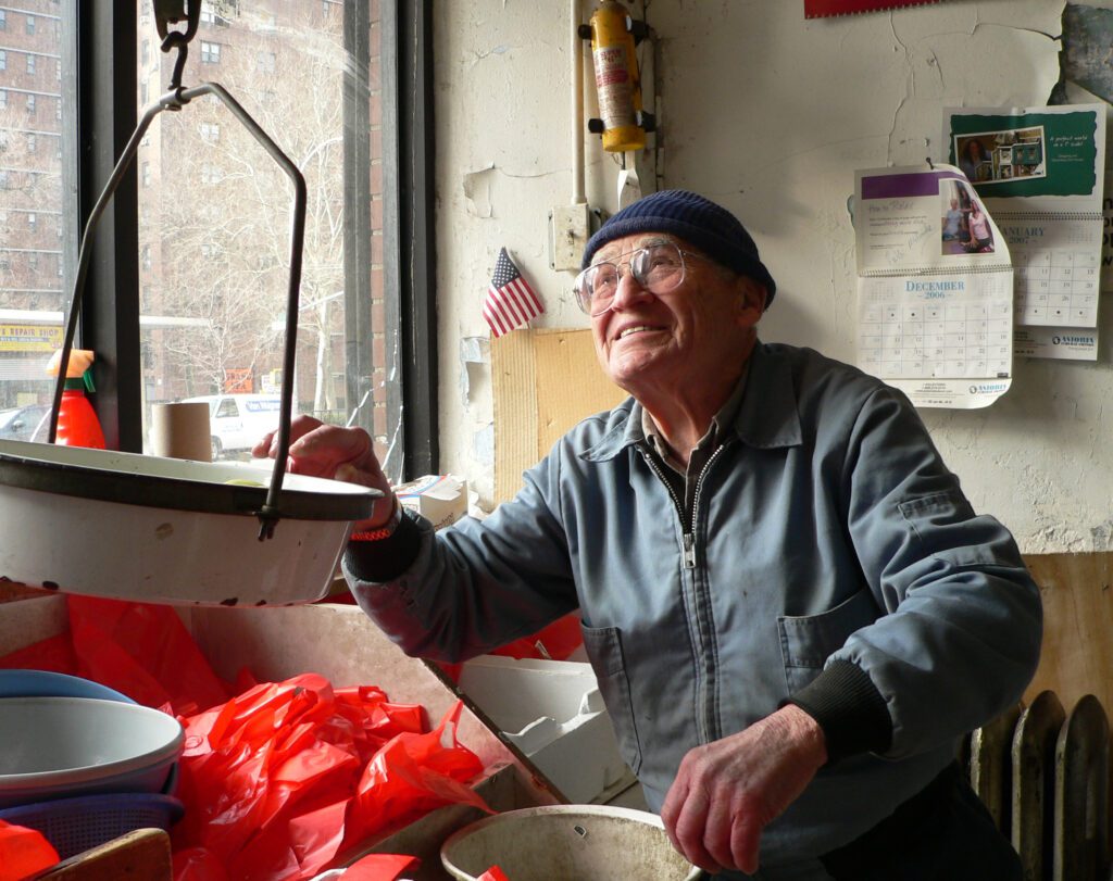 George, the produce man on Grand Street, 2006. He flirted with the ladies and argued with the other cranky proprietors and charged next to nothing. He and the tenement building where he worked in a tattered storefront are long gone.