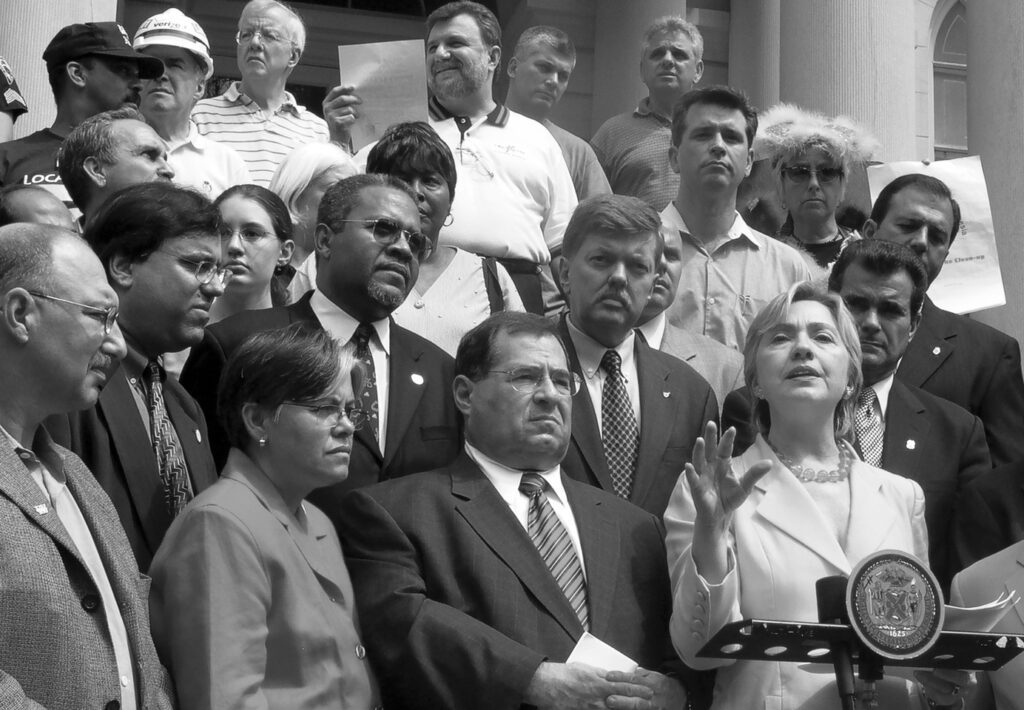 Hillary Clinton, New York senator in 2003, calls for hearings because the federal EPA lied after 9/11, saying the air was safe to breathe when it wasn't. US Rep. Jerrold Nadler is on her left. City Hall.