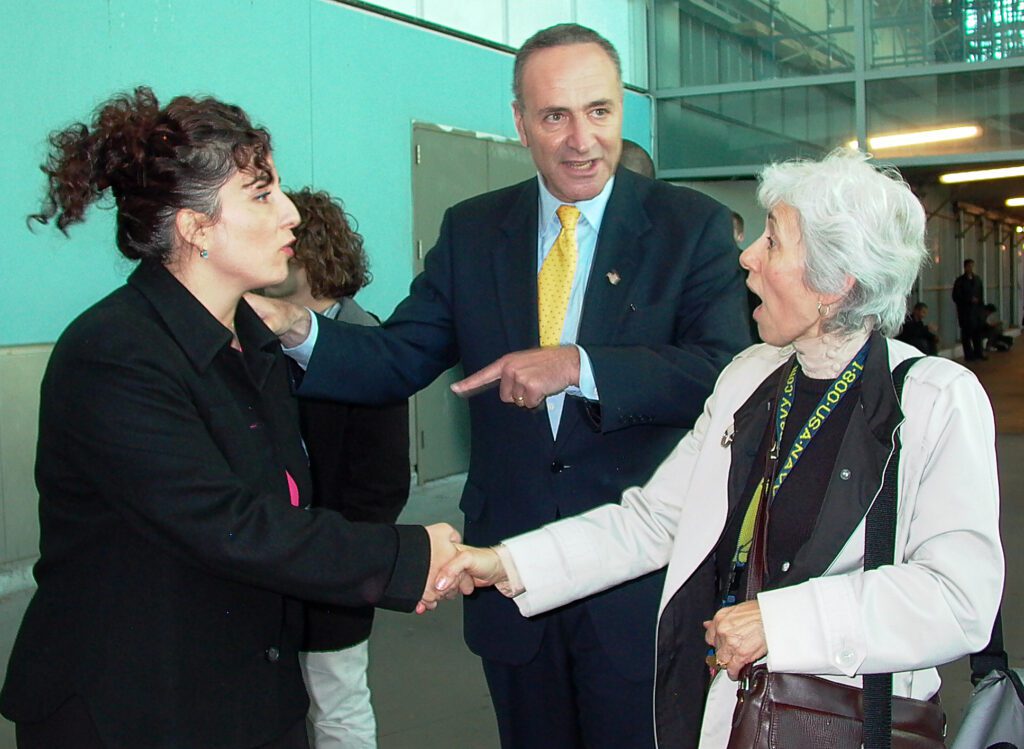 Senator Chuck Schumer campaigns by the Staten Island ferry in 2004 for Diane Savino, left, who was running as a newcomer for a Democratic seat in the New York State Senate for Staten Island and parts of Brooklyn. She won and became part of the Independent Democratic Caucus, which aligned with Republicans. She did support Marriage Equality. Despite her subsequent record blocking good legislation, I always liked this photo. Everyone in it is dynamic and it tells the story.