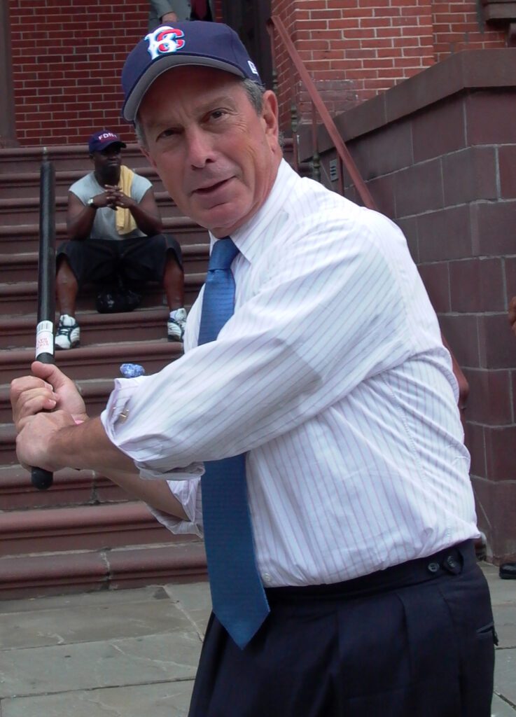 New York City Mayor Michael Bloomberg showing his stickball stance in a game between the Fire and Police Departments.