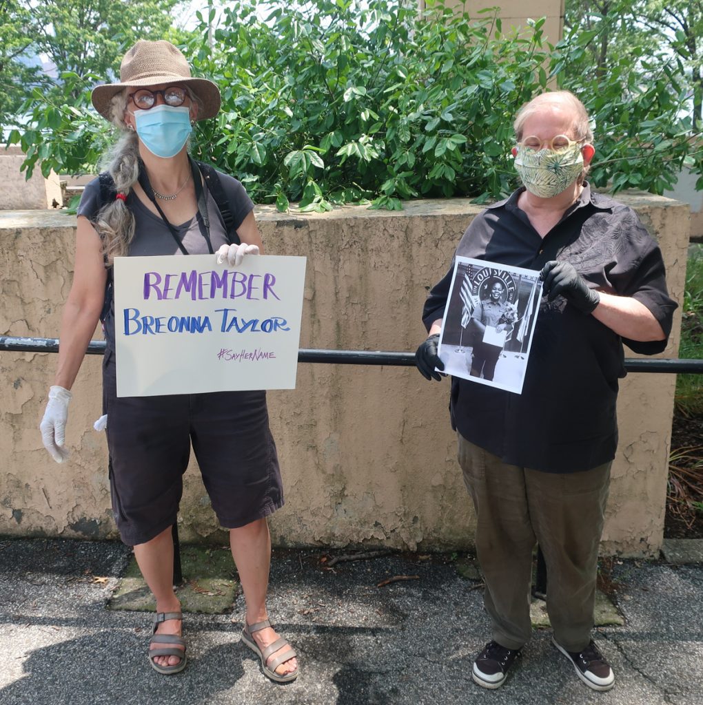 Black Lives Matter signs for Breonna Taylor held by me and Amy Berkov