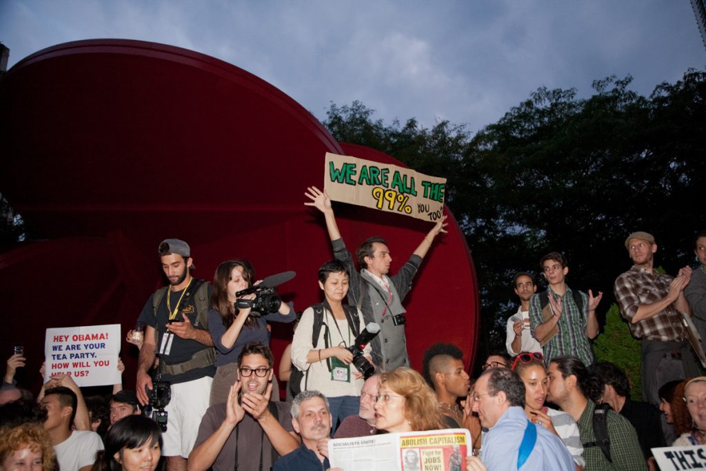 "We are all the 99%" sign at an Occupy Wall Street protest, 1 Police Plaza, Manhattan