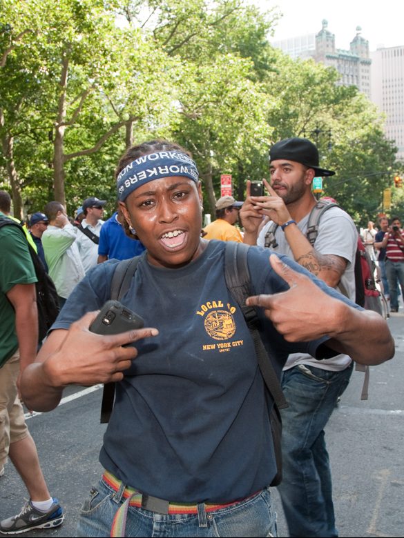 Woman at workers' march downtown Manhattan wearing her Local Union 40 of the International Association of Bridge, Structural, Ornamental, & Reinforcing Iron Workers t-shirt.