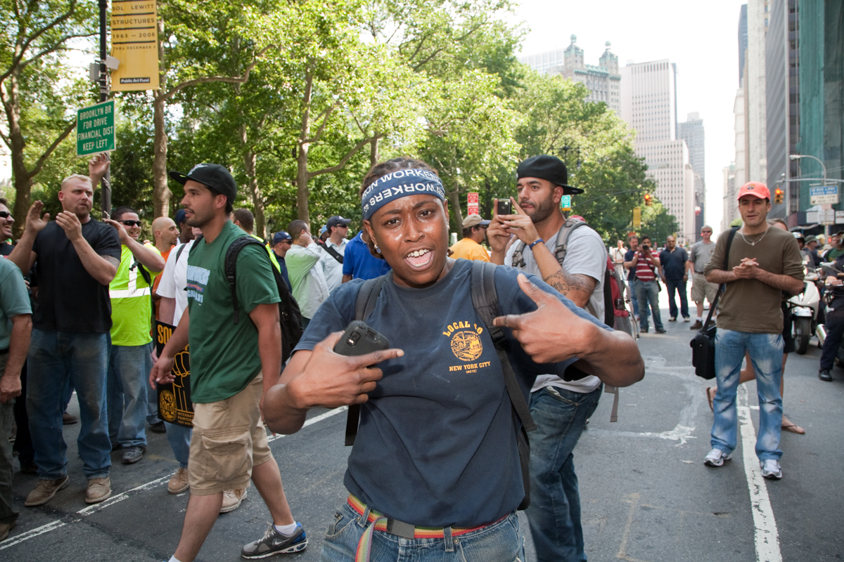 Woman at workers' march downtown Manhattan wearing her Local Union 40 of the International Association of Bridge, Structural, Ornamental, & Reinforcing Iron Workers t-shirt.