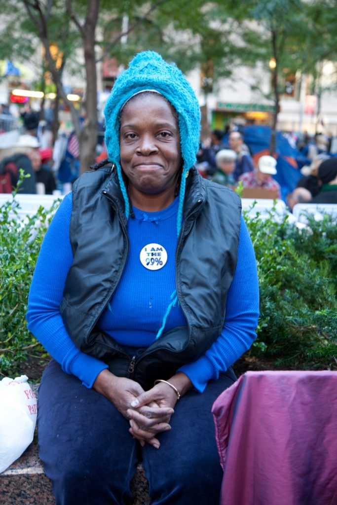 Occupy Wall Street protester wearing a button, "I am the 99%"